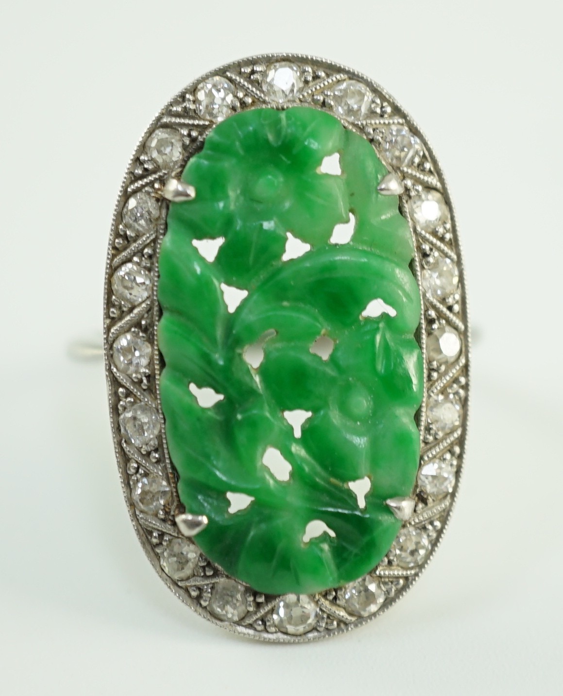 A 1920's/1930's white gold, jadeite and diamond set oval dress ring